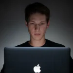 Person behind a Macbook Pro