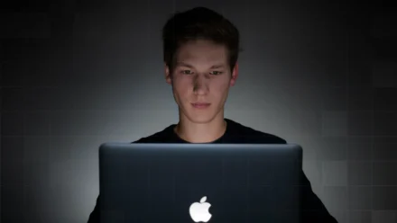 Person behind a Macbook Pro