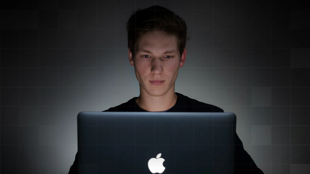 Person behind a Macbook Pro