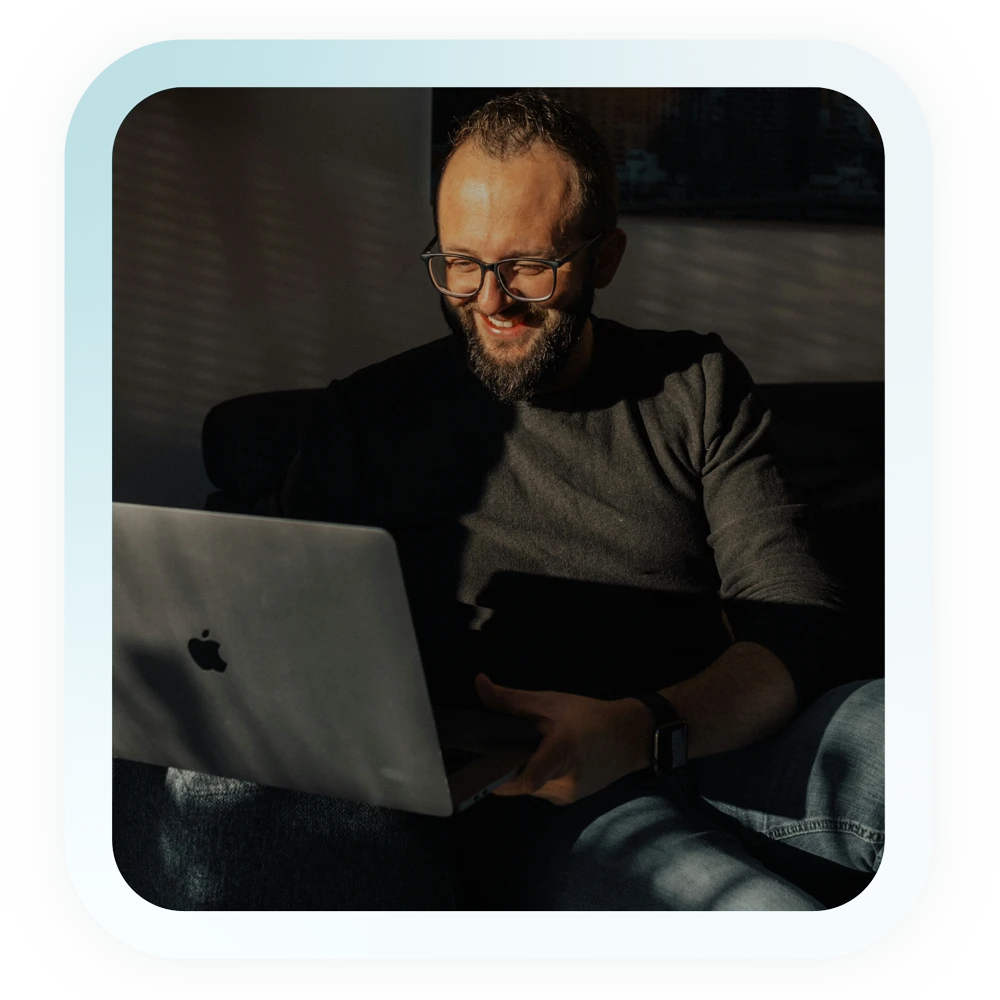 A man in front of a Macbook Pro