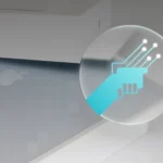 A blue icon of two hands shaking over a silver Macbook Air