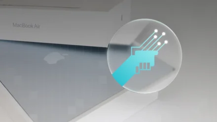 A blue icon of two hands shaking over a silver Macbook Air