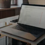 IT team reviewing an Apple MDM evaluation checklist on a laptop