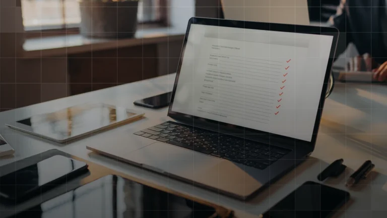 IT team reviewing an Apple MDM evaluation checklist on a laptop