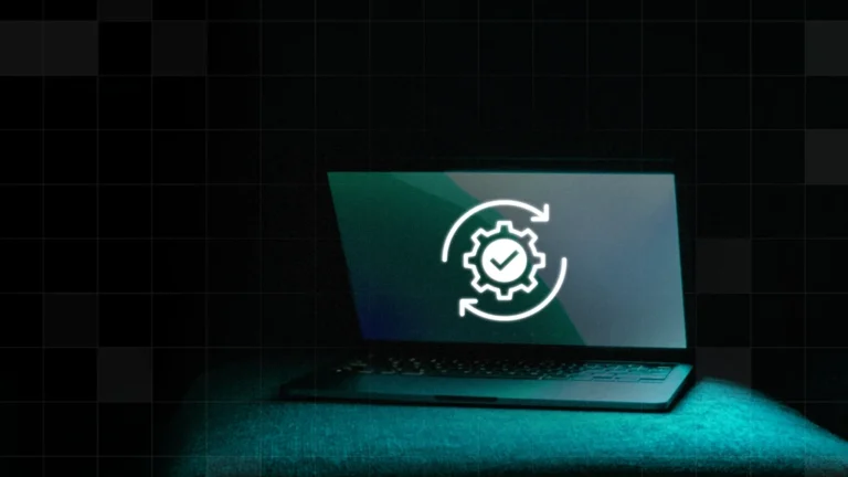 A Mac computer with a white gear checkmark icon - it’s updating itself.