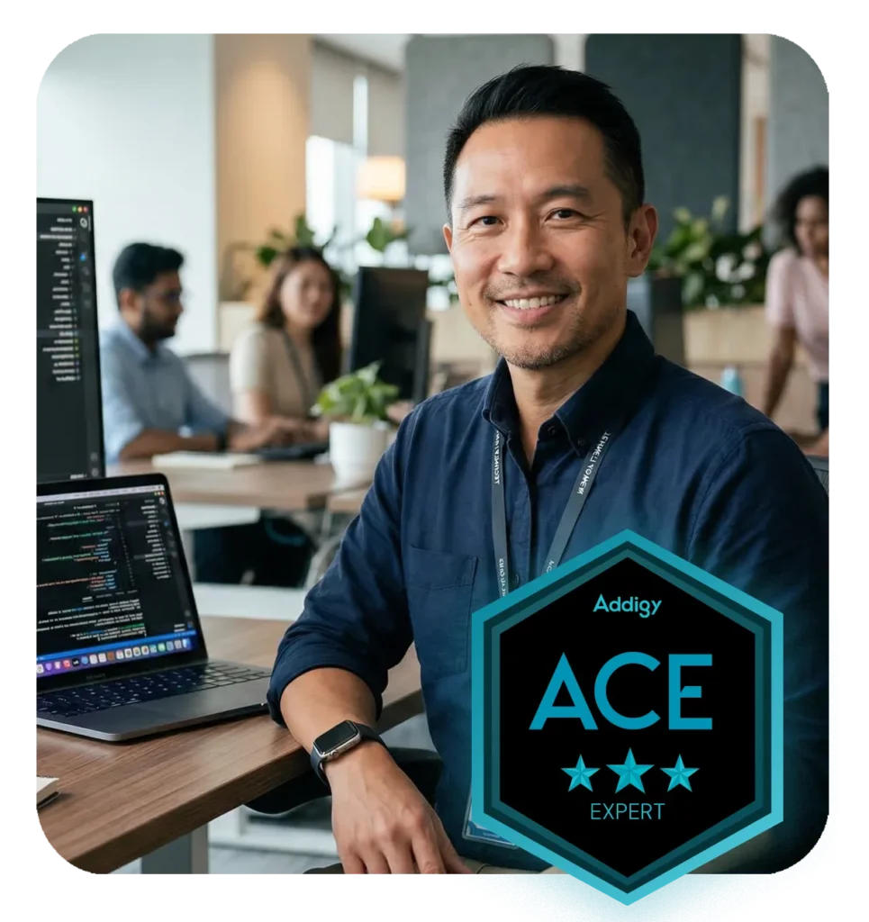 IT professional smiling while working on an Apple MacBook in a modern office, with dashboard cards showing credentials issued and credentials 