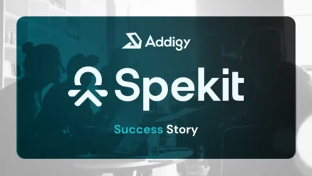 Addigy and Spekit Success Story feature image. A dark teal-tinted photo of people in a meeting sits inside a rounded card, with the Addigy logo at top, the Spekit logo prominently in the center, and 'Success Story' in teal and white at the bottom.